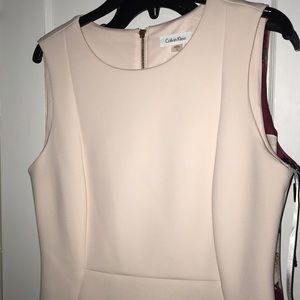 Light pink/cream colored fitted dress.
